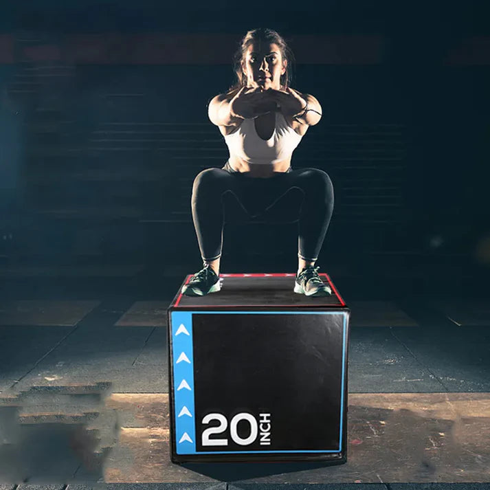 Person performing a box jump on a 20-inch box in a gym setting