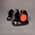 Black and red dumbbell-shaped object on a gray background