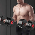Man lifting adjustable dumbbells against a dark background
