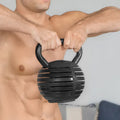 Man holding a black textured kettlebell against a neutral background