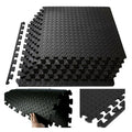 Black foam puzzle mats with interlocking design on a white background