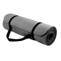 Gray yoga mat with black straps on a white background