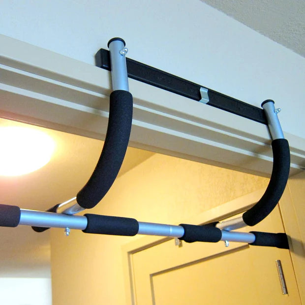 Doorway pull-up bar attached to a ceiling and door frame.