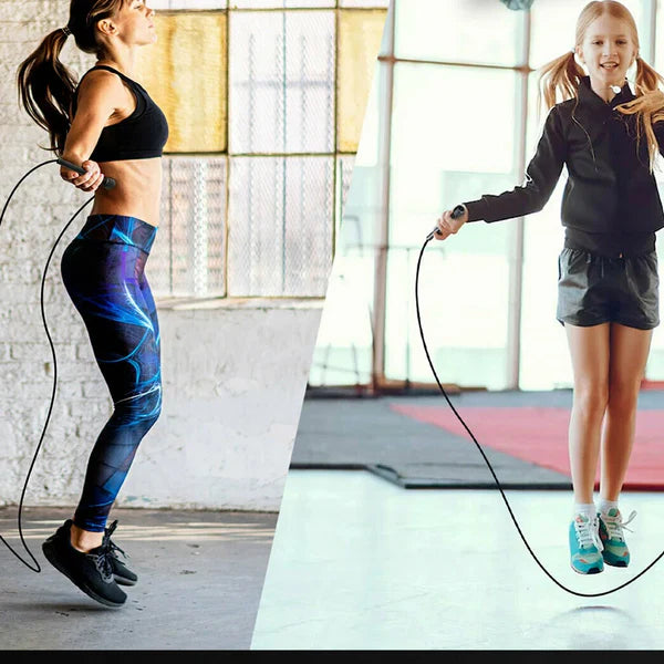 Black jump rope coiled on a white background